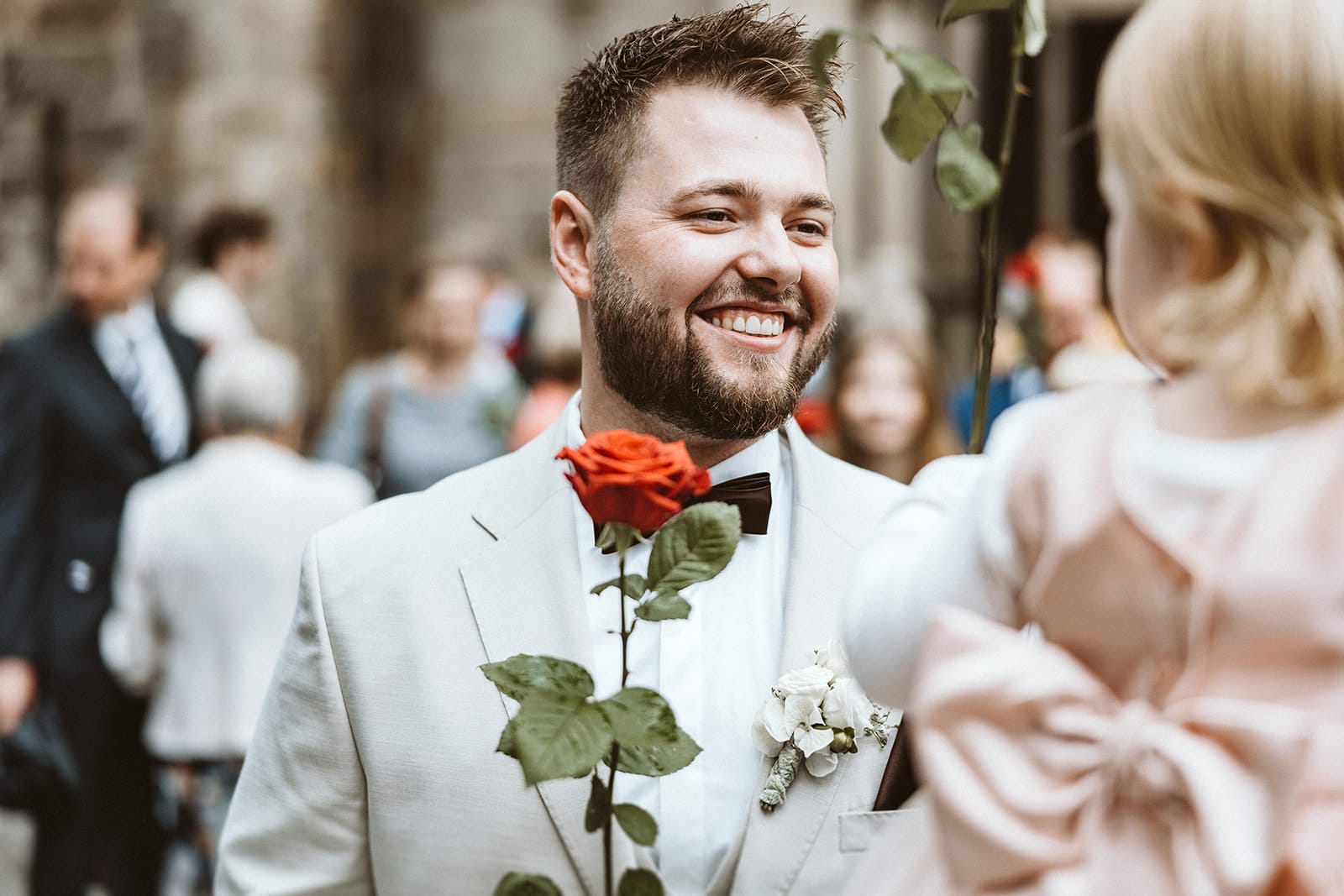 St. Lambertus Mettmann Trüffelschwein Hilden Hochzeitsfotograf - Bräutigam lächelt zur Gratulation zu seiner Tochter