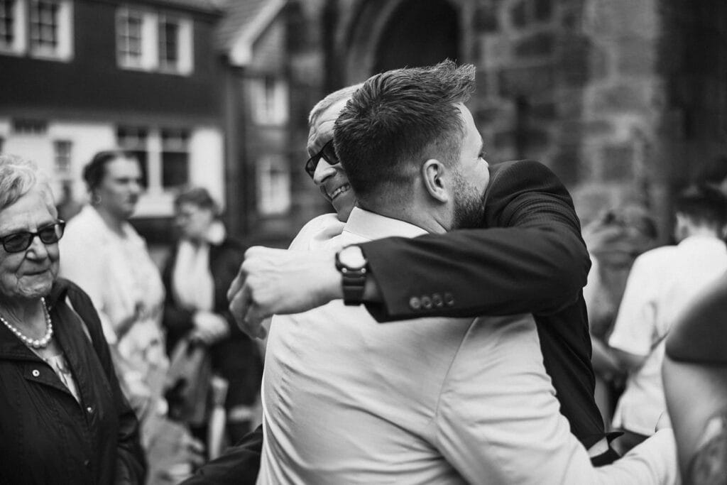 St. Lambertus Mettmann Trüffelschwein Hilden Hochzeitsfotograf - Brautvater umarmt Braut