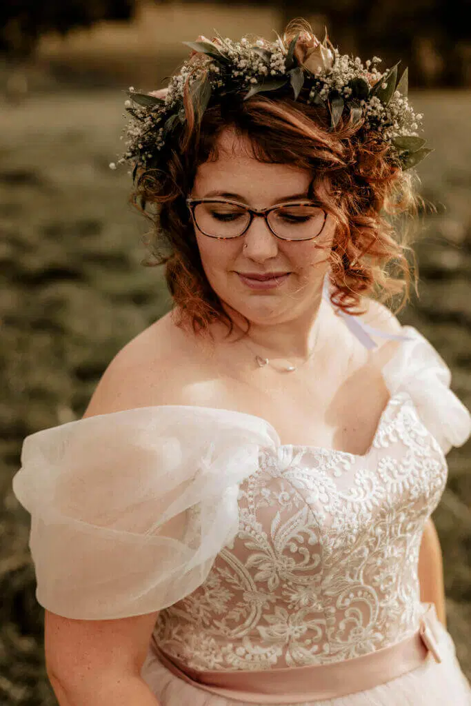 Warum wurde früher in schwarz geheiratet - Braut im weißen Brautkleid schaut seitlich zur Seite
