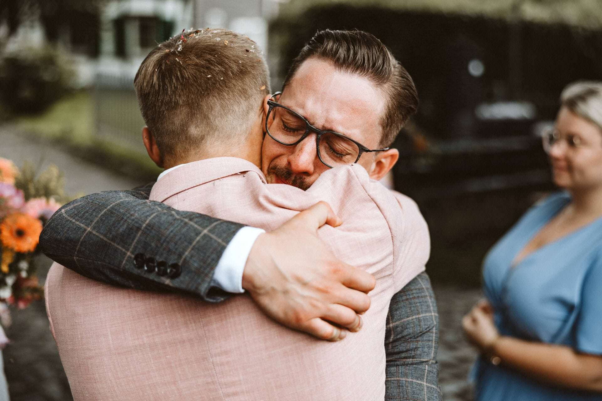 Hochzeitsfotograf Bochum Hochzeit Heiraten Hochzeitsfotoss - Männlicher Trauzeuge umarmt Bräutigam sehr eng umschlossen. Der Trauzeuge hat geschlossene Augen und beginnt fast zum Weinen mit Freudentränen an