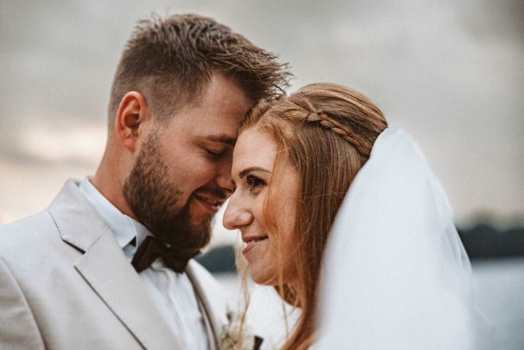 Hochzeitsfotograf Remscheid Hochzeit Heiraten Hochzeitsfotos - Das Brautpaar lehnt ihre Stirn einander. Der Bräutigam hat die Augen verschlossen, während die Braut am Bräutigam vorbeischaut. Beide lächeln